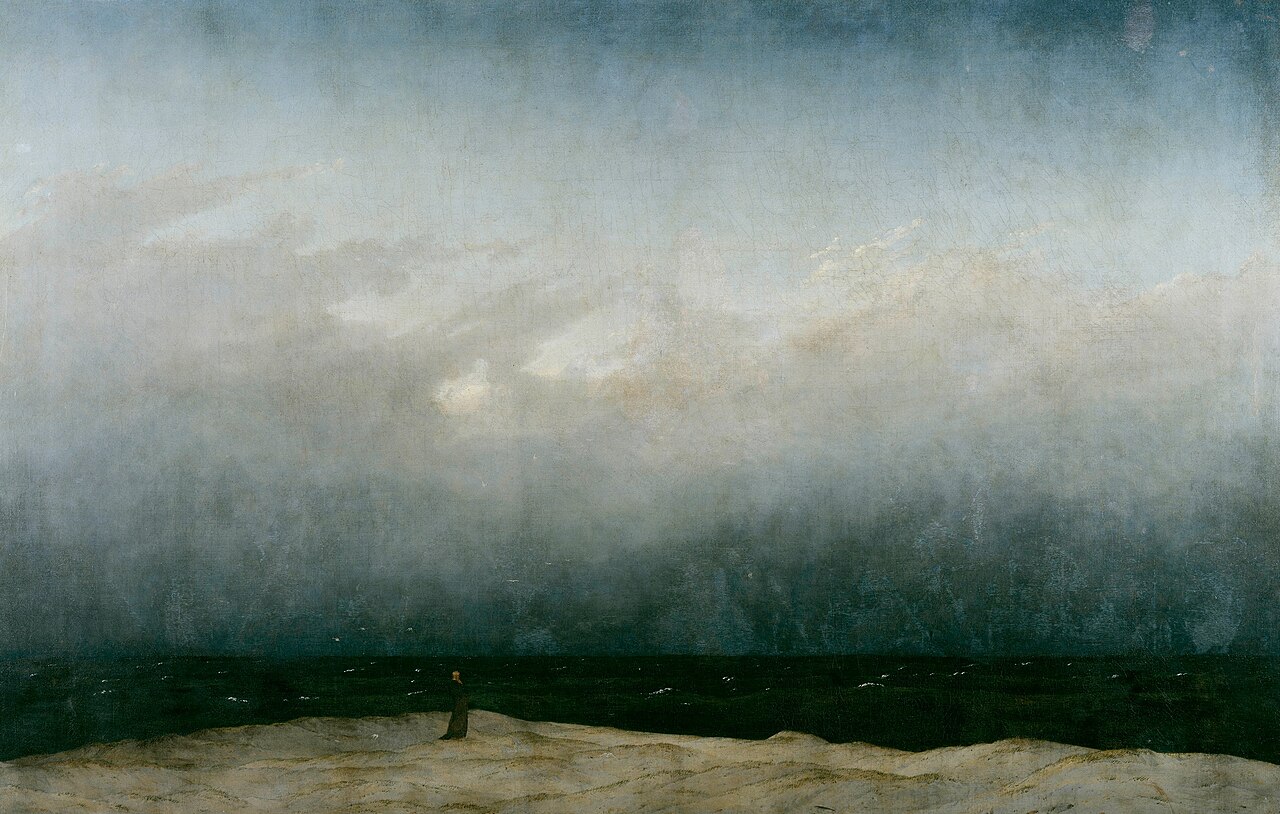 Friedrich's Der Mönch am Meer: one small figure on a strip of shore under an enormous sky
